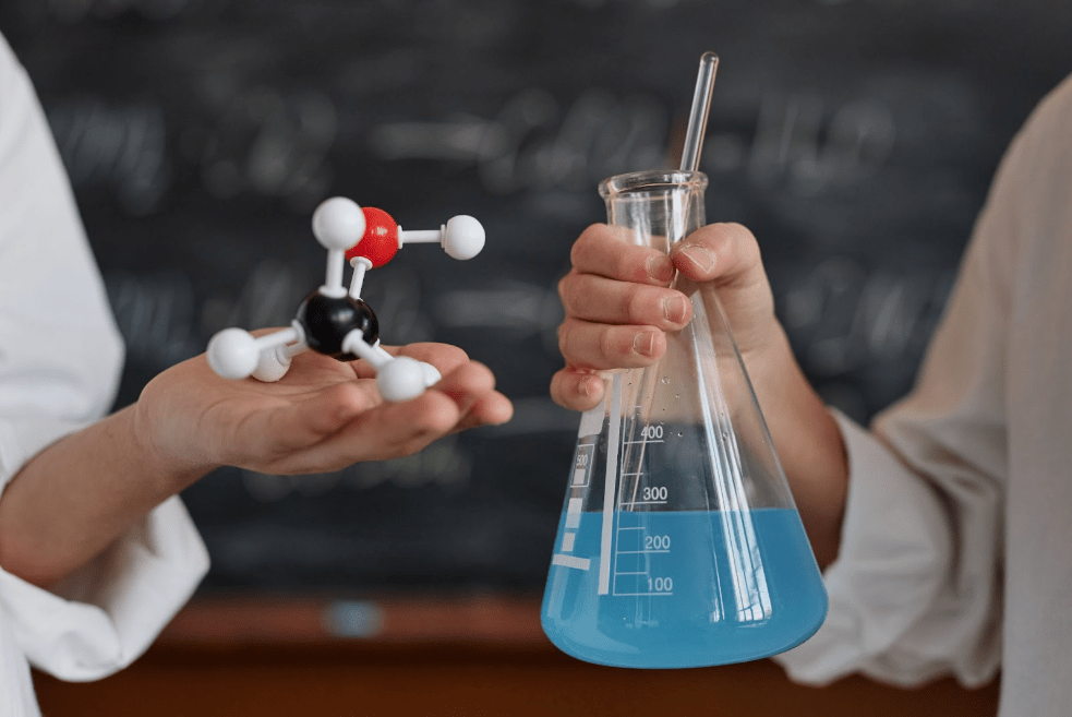 Two people holding chemicals