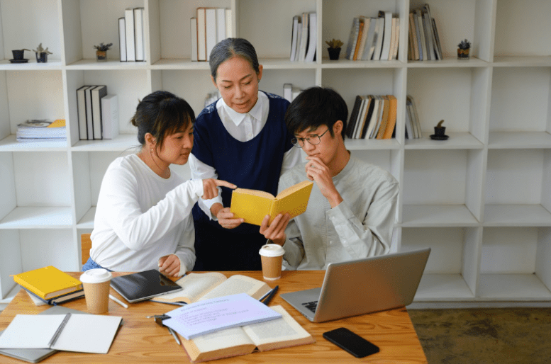Two teenagers tutored by a tutor