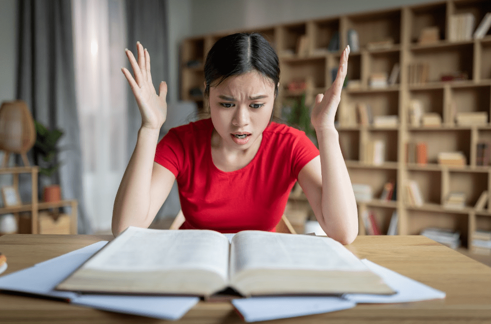 A woman stressing out over studying